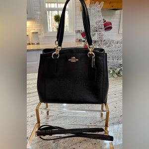 Coach black pebble leather Minetta bag with detachable leather crossbody strap.